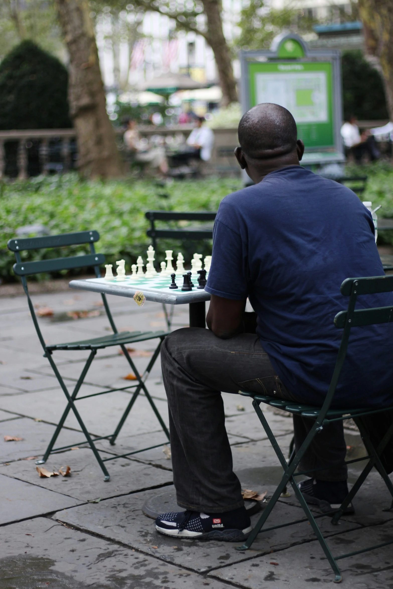 an individual is looking at the small chess