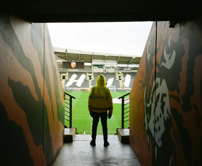 a person standing on the steps of a soccer field