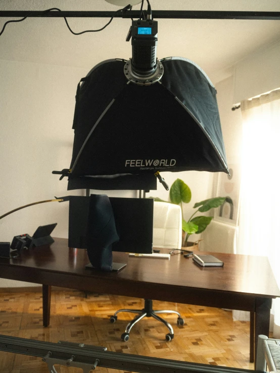 a black office chair sitting on top of a wooden desk