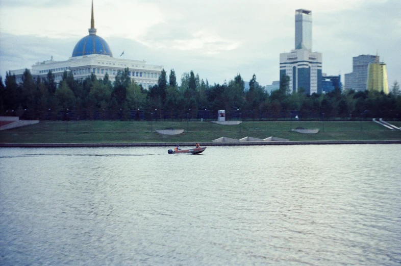 a small boat floating on top of a lake