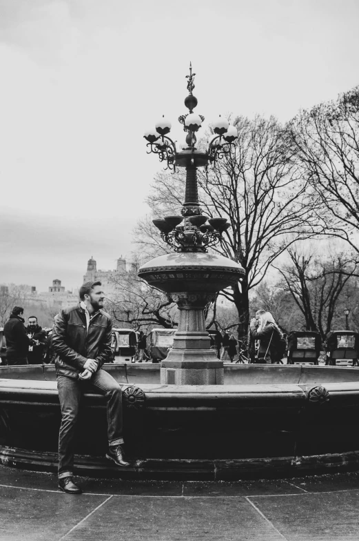 a black and white po of a man playing guitar