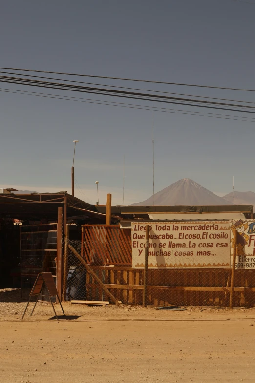 a sign on the side of a building in front of mountains