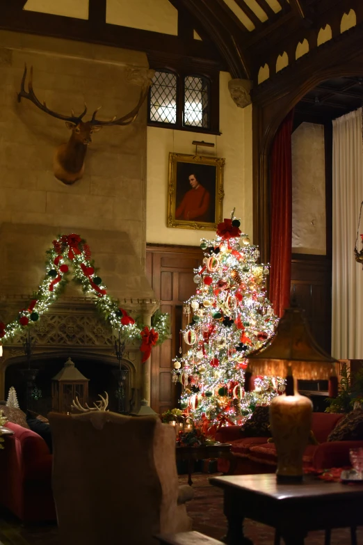 decorated christmas trees and gifts in a large living room