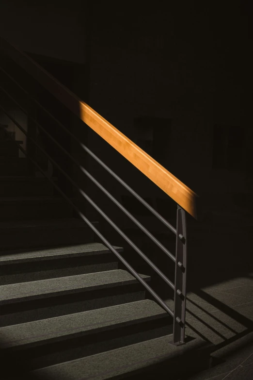 a set of stairs lit up by a single light at night