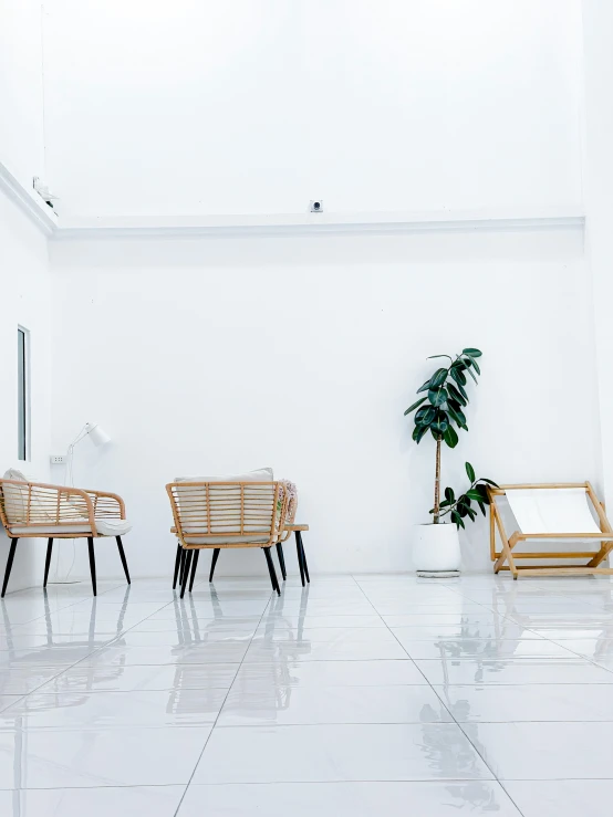 three wooden chairs are against a white wall