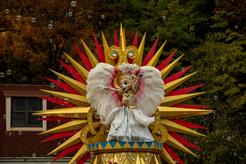 a float with an angelic figure on it and a lot of decoration
