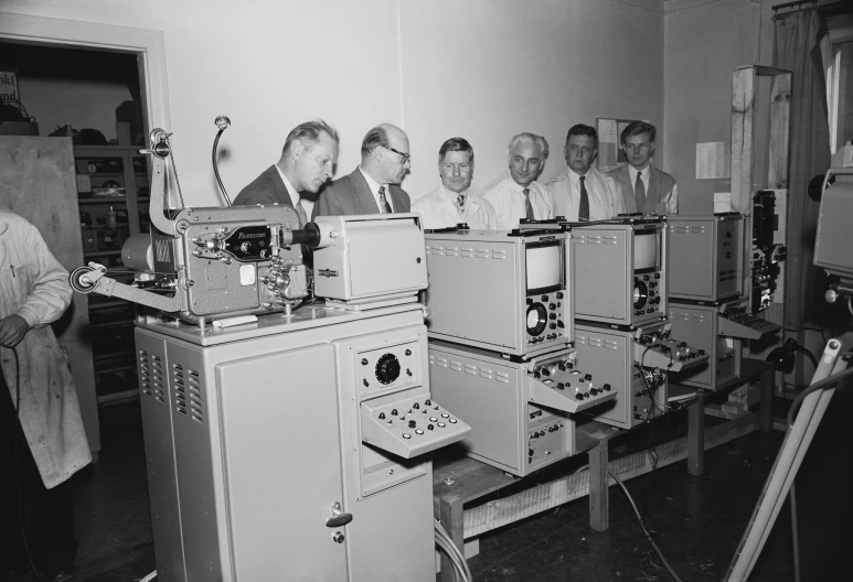 a group of men sitting at machines in a room