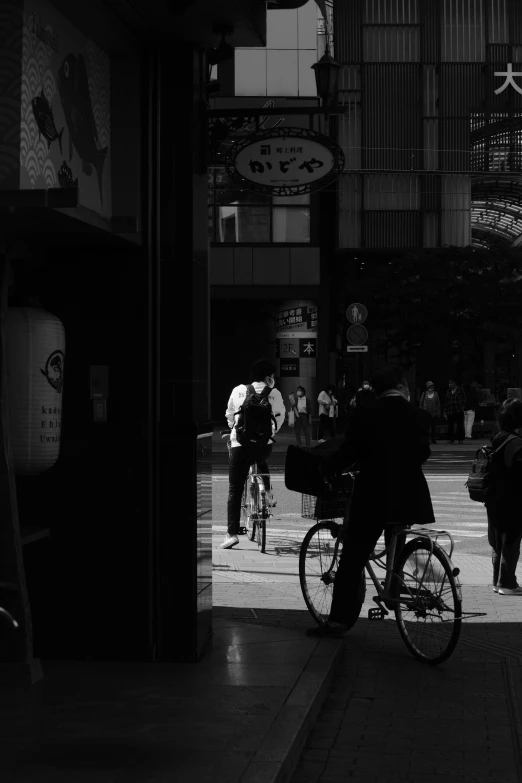 a black and white po of people and bikes on a sidewalk