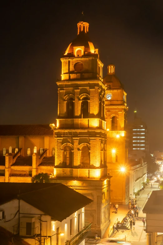 an old building at night with several clock towers