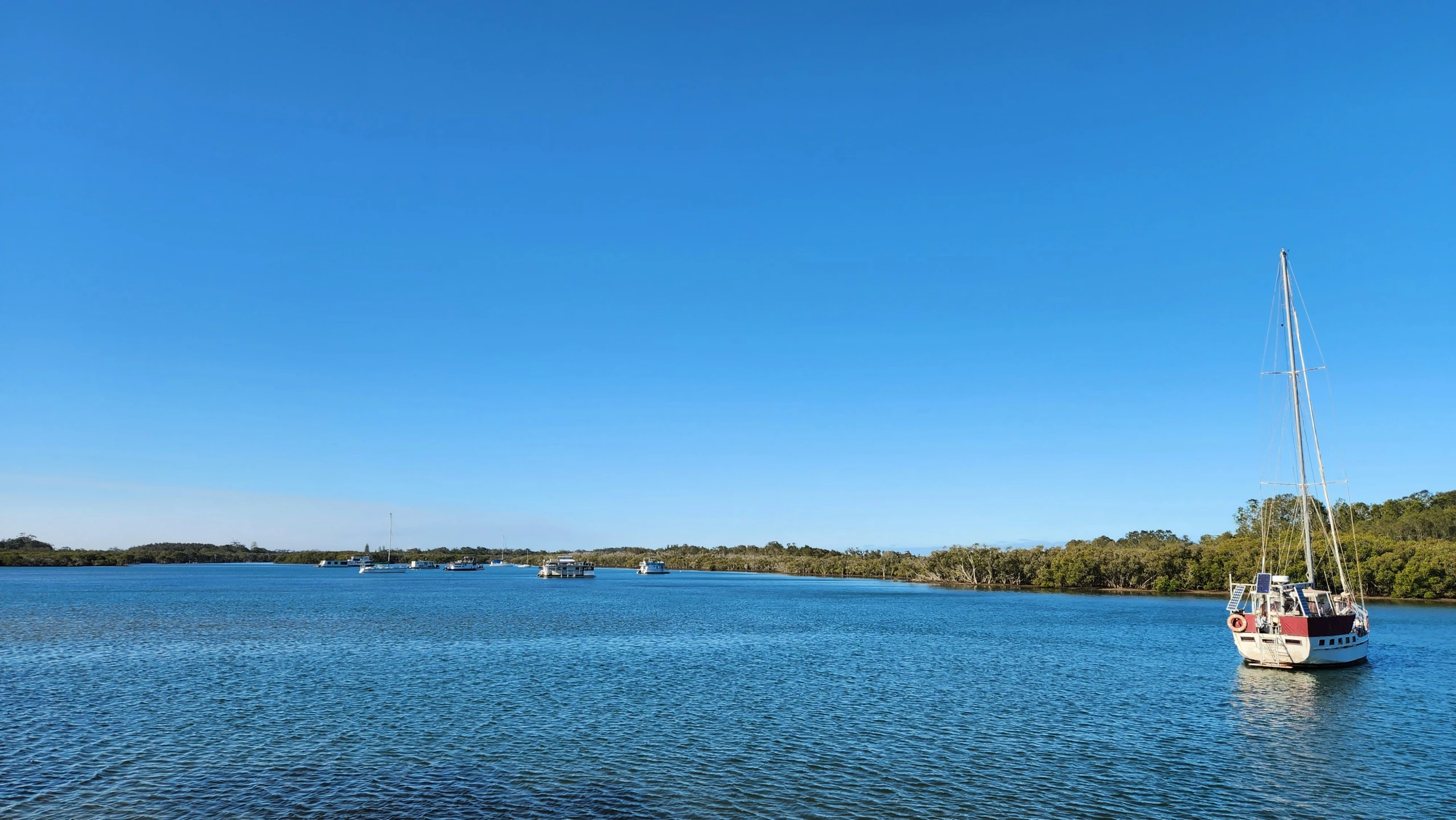 a sailboat on a clear blue lake