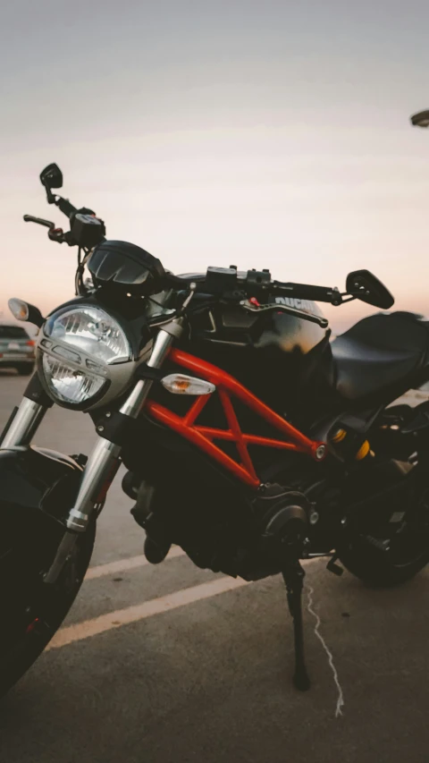 a red and black motorcycle in parking lot