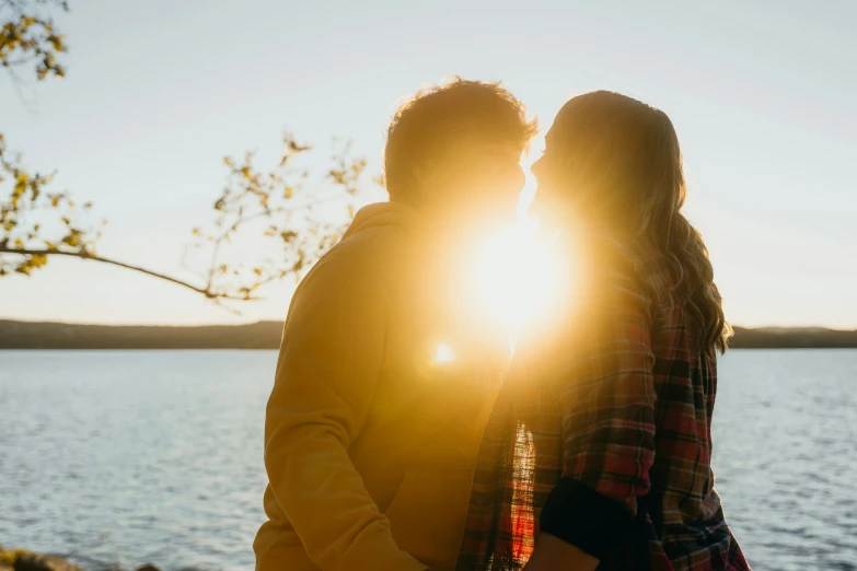 two people standing close together with their arms around each other