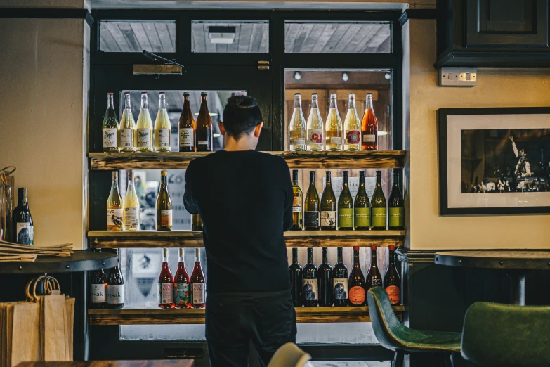 the man is getting drinks out of the store