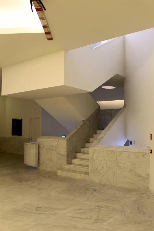 a long marble stairway in the middle of an empty building