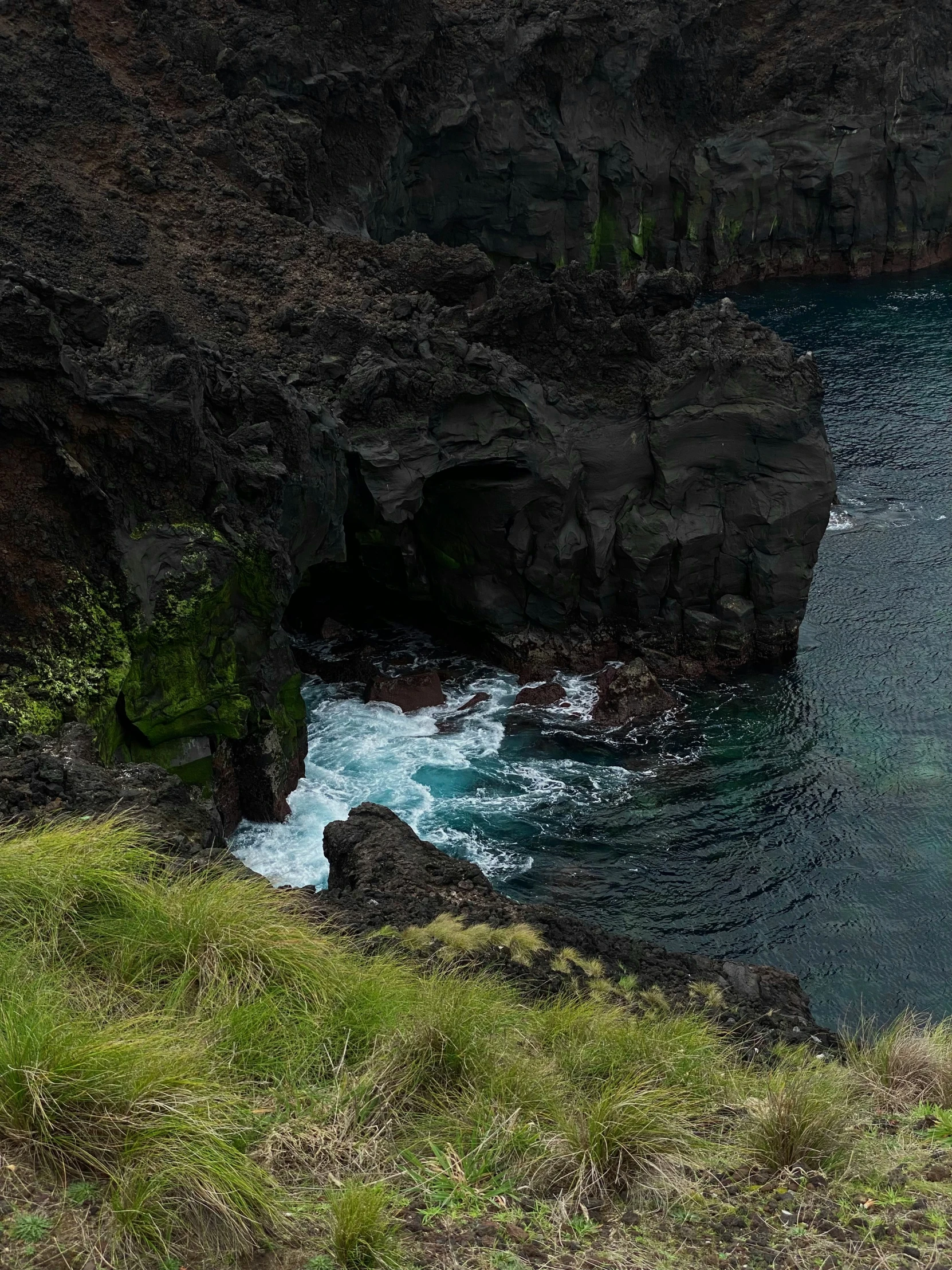 two people on the cliff by the ocean