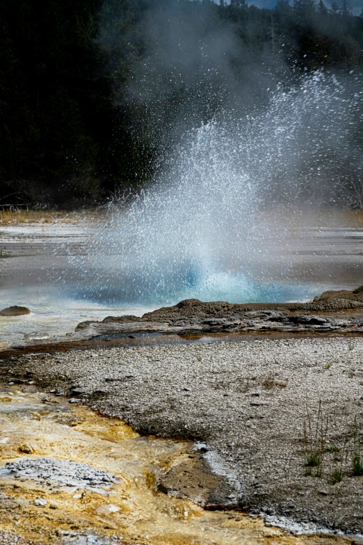 a  pipe spewing out of a  - water spring