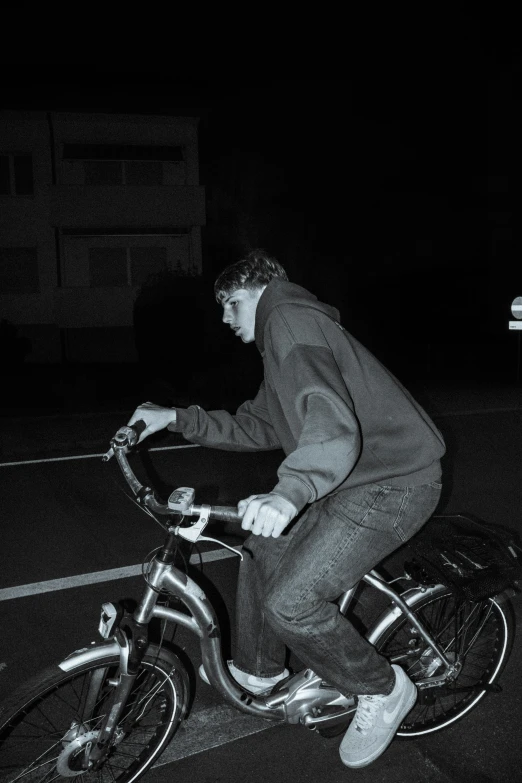 a black and white po shows a man on a bicycle