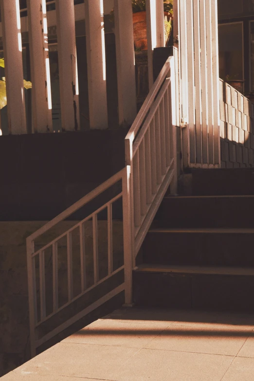 a person standing on stairs carrying a skateboard