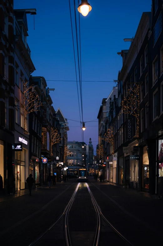 a city street at night with christmas lights