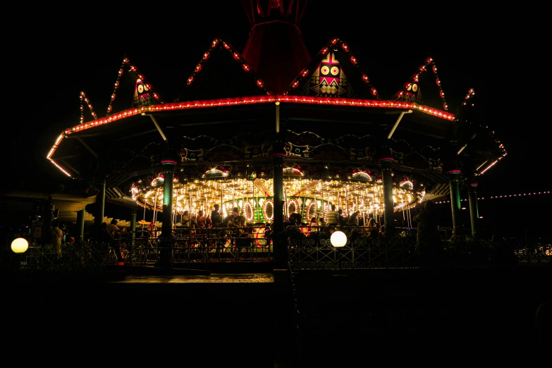 an image of a merry go round carousel at night