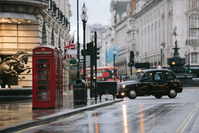 a london street with taxis and red telephone booths