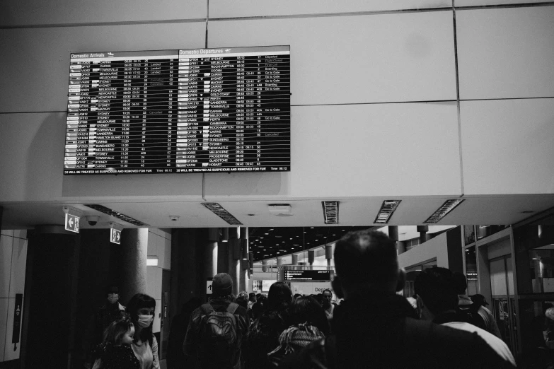 people wait to go inside the terminal for their flights