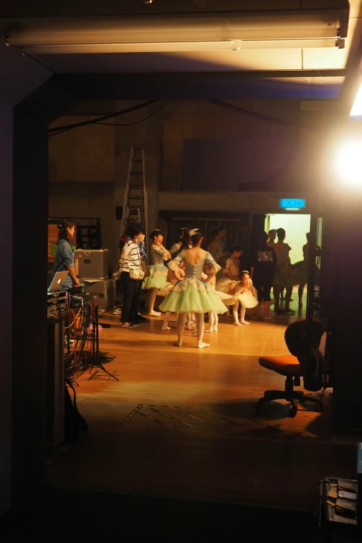 a young woman dances in a dimly lit room