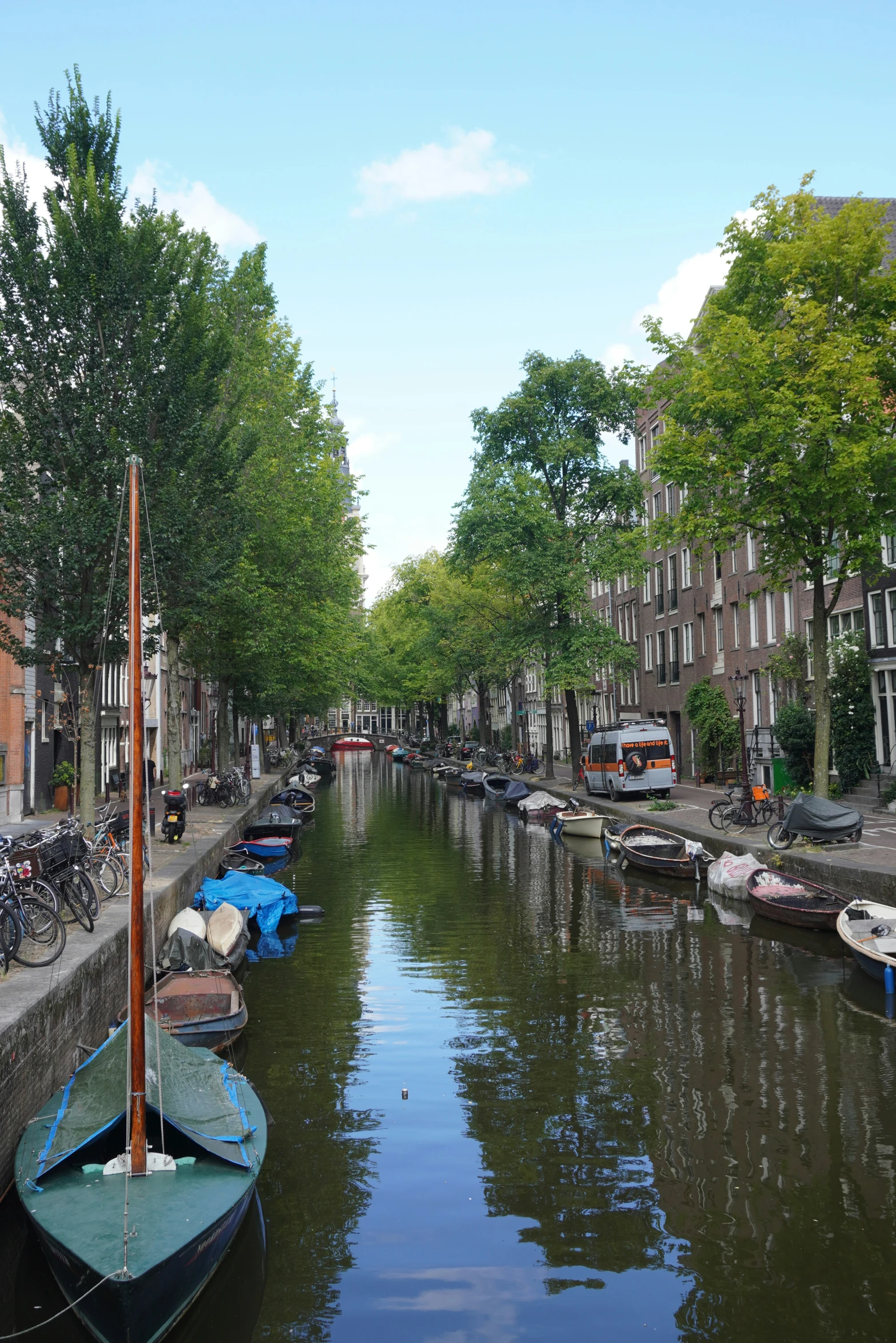 several boats on a canal in the middle of the town