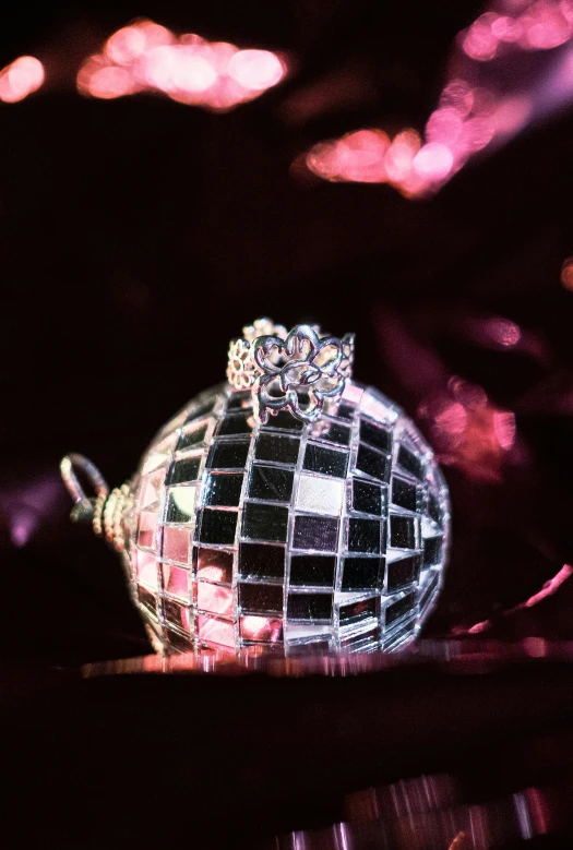 a disco ball sits on a table in the dark