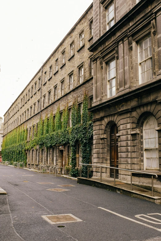 some people walking around outside of an old building