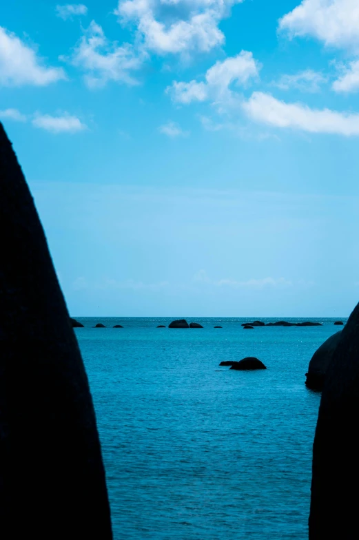 an island sits off the coast with blue sky