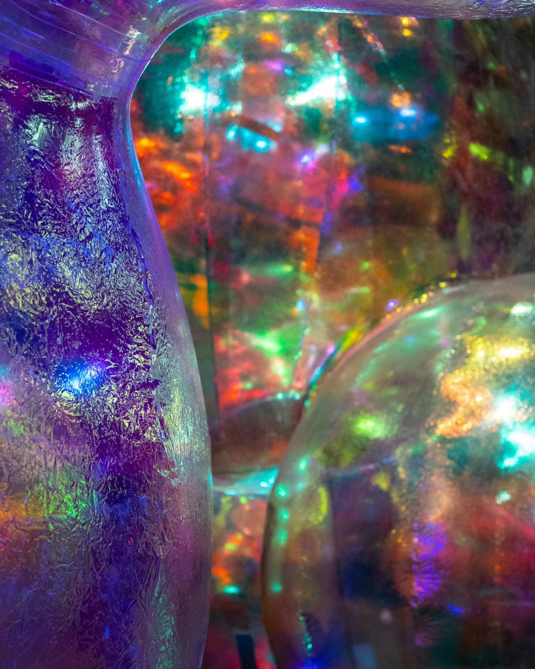 many colored bubbles float among the colorful lights