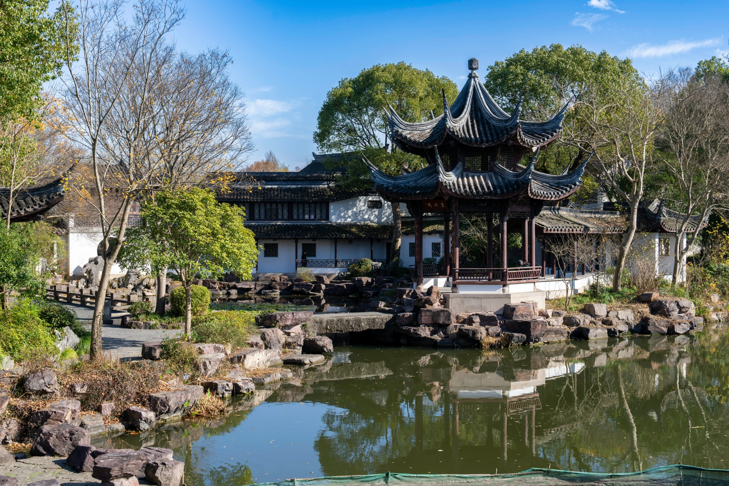 a pavilion in a pond near some trees