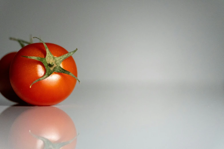 one tomato that has been placed on the table