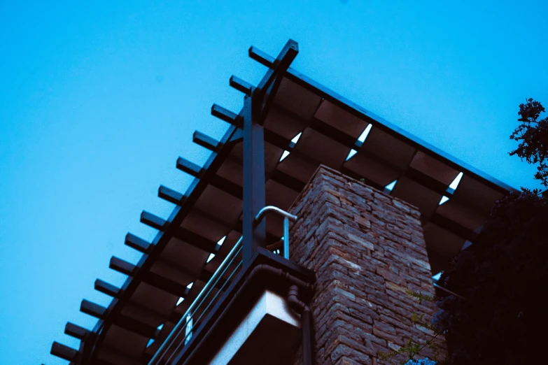 the top of a tall building with metal structure and pillars