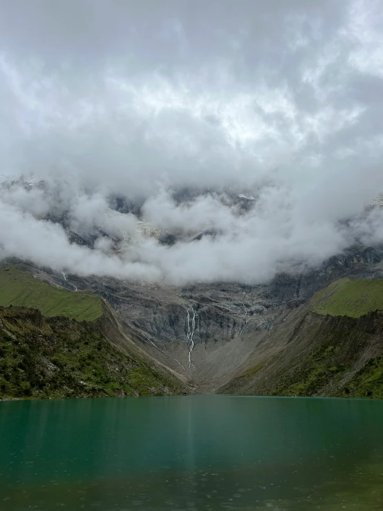 mountain landscape with water and clouds above