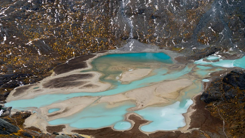 a river flows from a large mountain