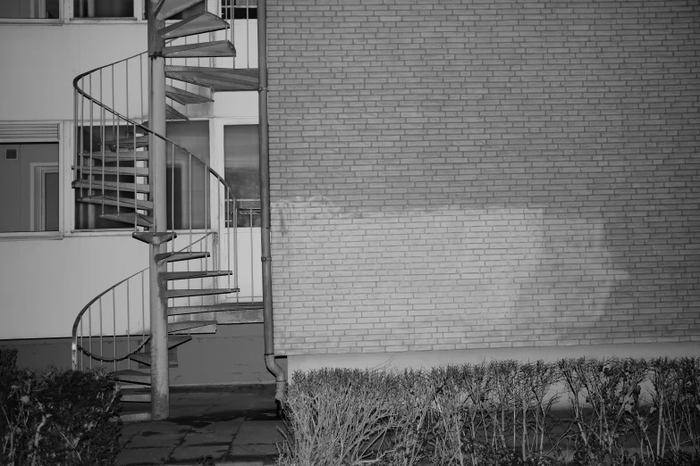 an empty sidewalk with a staircase to a building