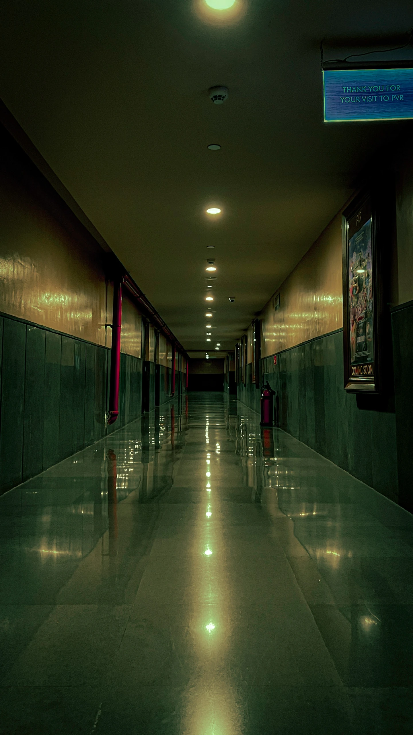 an empty hallway that is made of concrete