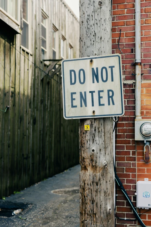 a don't enter sign attached to a telephone pole