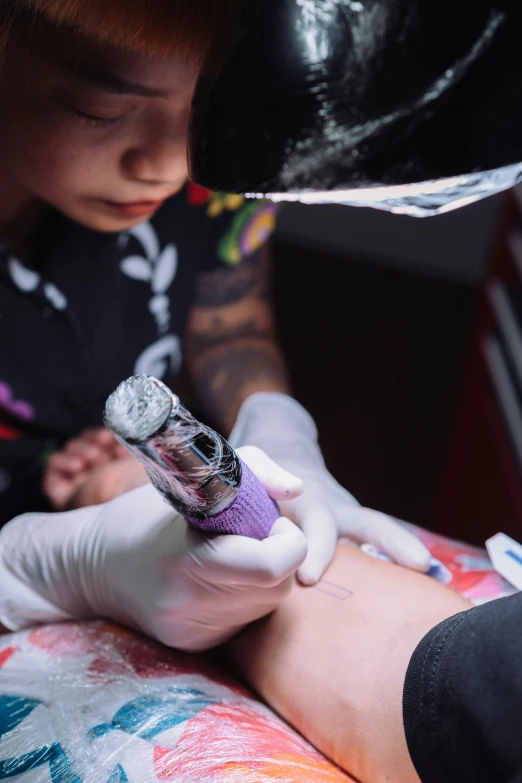 a man getting his tattoo done by a professional