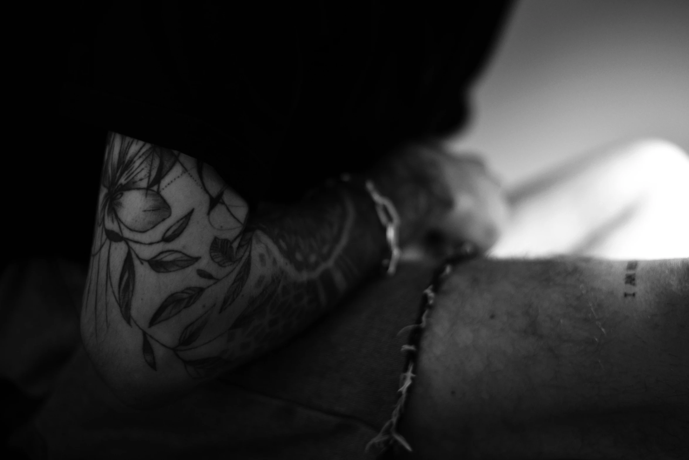 a man's arm with tattoos and his left wrist