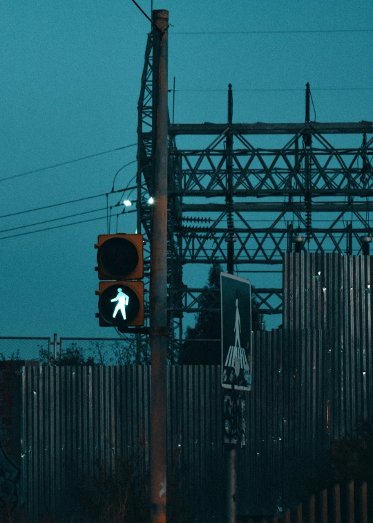 the traffic light is illuminated green for people to walk through