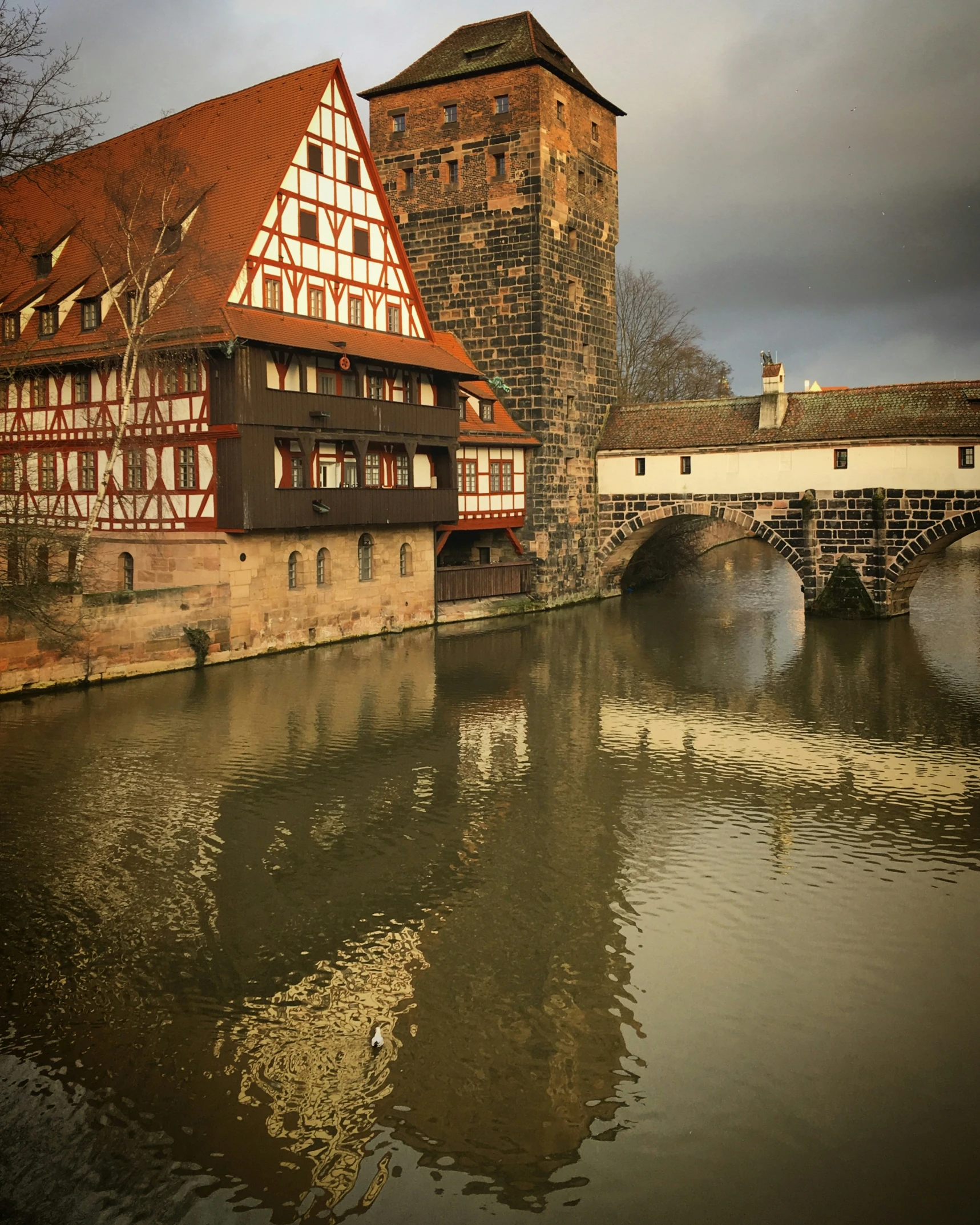 a water way with buildings in the background and bridge