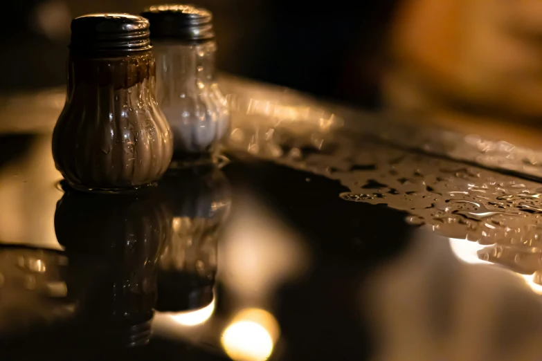 two salt and pepper shakers on top of a kitchen counter