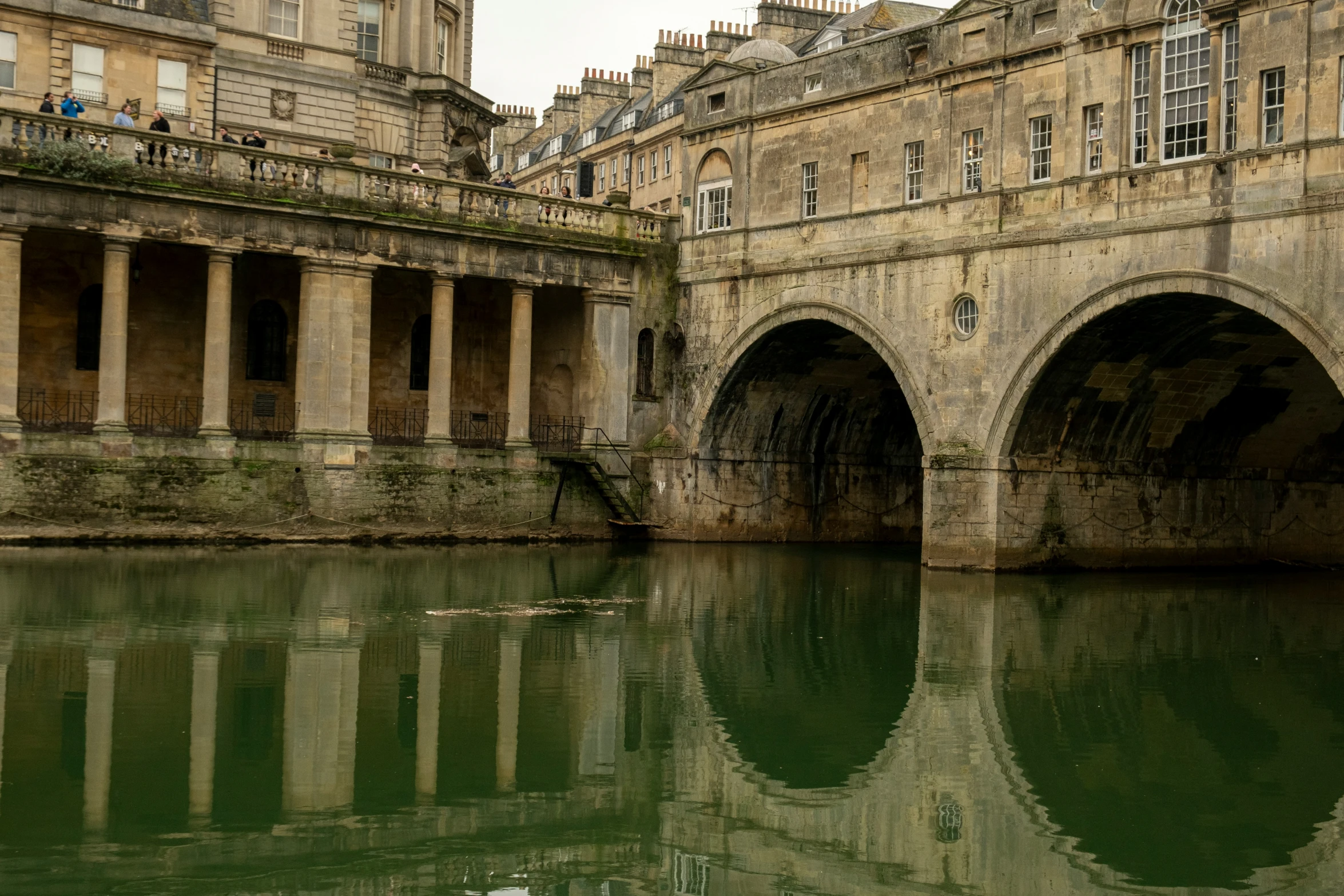 a bridge and water that leads into the city