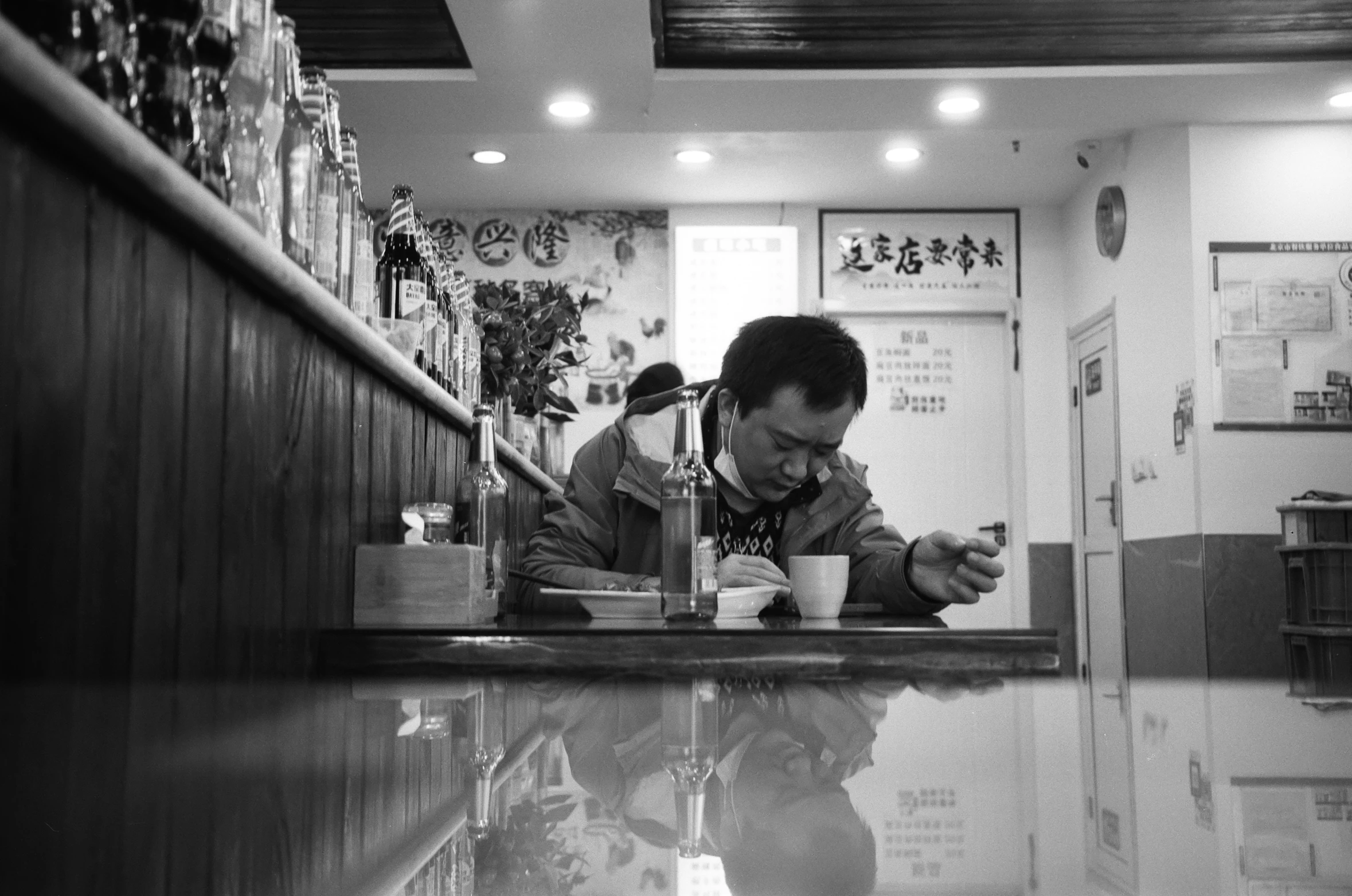 a man sitting at a table in a restaurant