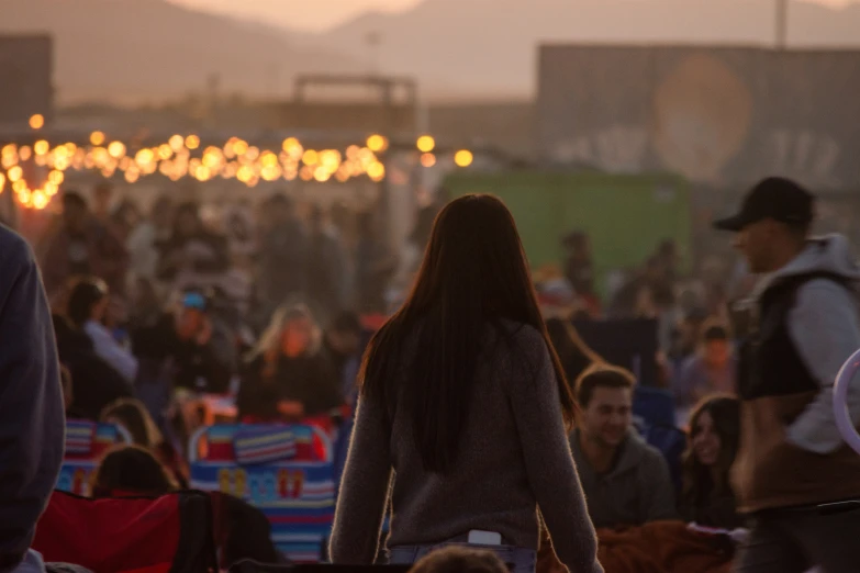 a crowd of people standing and sitting in the dark