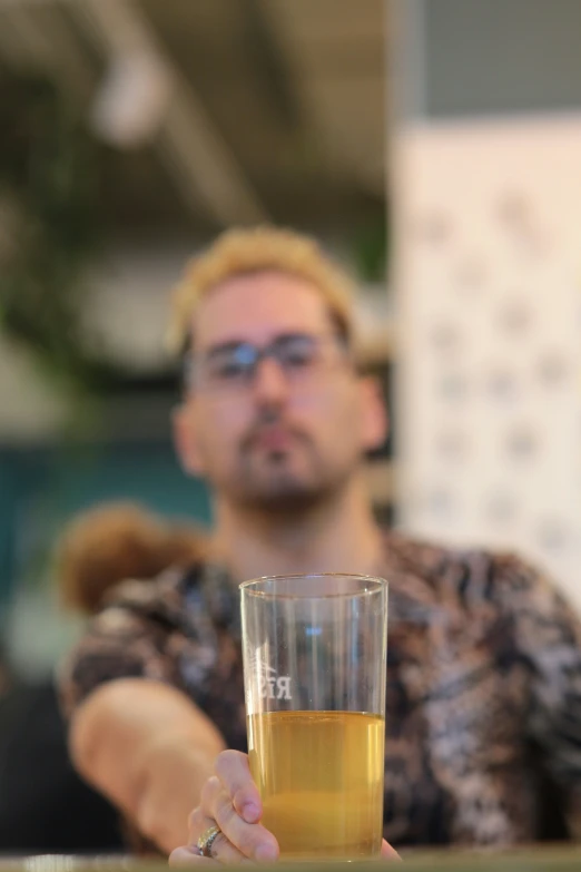 a man holding a beer glass in his hand