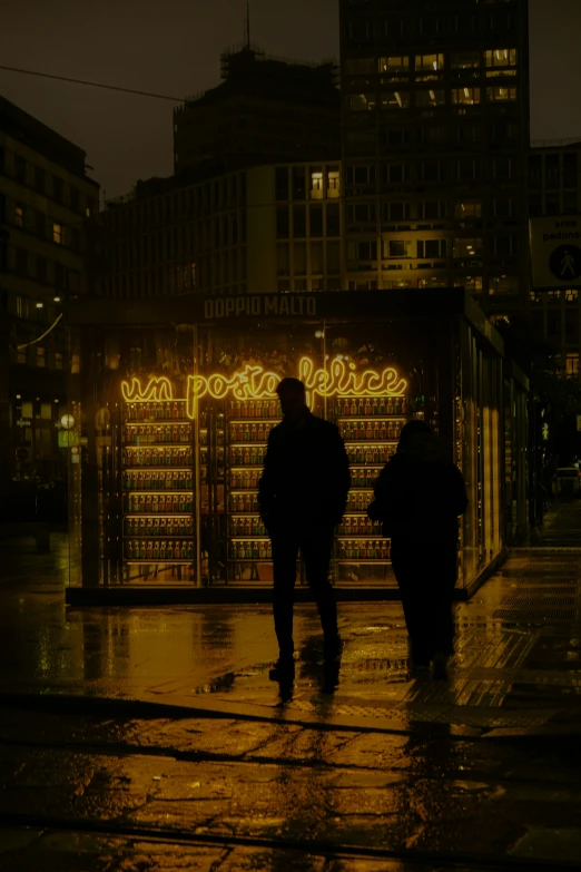 a group of people walking on a rainy sidewalk